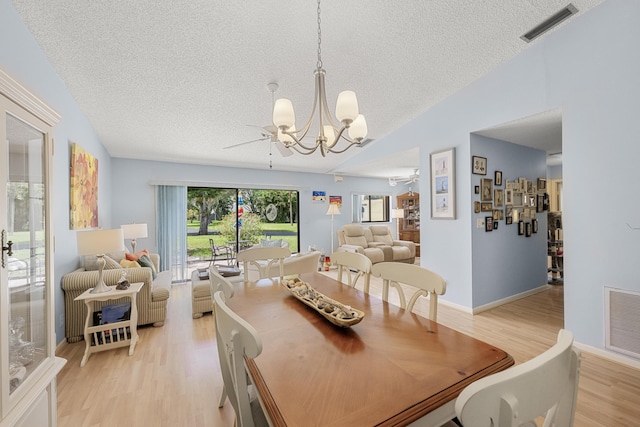 1 Danby Pl, Boynton Beach, FL 33426 - dining area with a chandelier, a textured ceiling, light wood finished floors, and vaulted ceiling