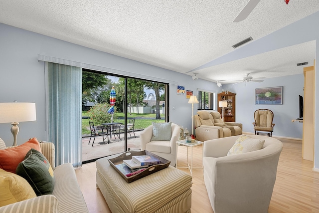 1 Danby Pl, Boynton Beach, FL 33426 - living area with ceiling fan, a textured ceiling, lofted ceiling, and light wood-style flooring