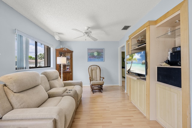 1 Danby Pl, Boynton Beach, FL 33426 - living area featuring ceiling fan, light wood finished floors, a textured ceiling, and baseboards