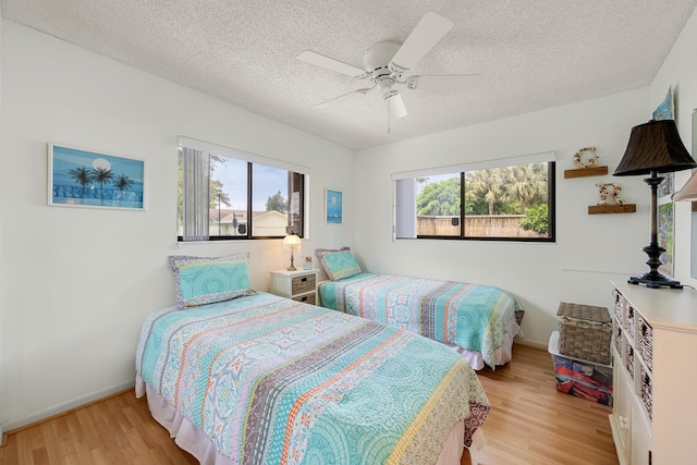 1 Danby Pl, Boynton Beach, FL 33426 - bedroom with light wood-style floors, baseboards, ceiling fan, and a textured ceiling