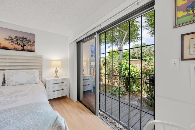 1 Danby Pl, Boynton Beach, FL 33426 - bedroom featuring multiple windows, light wood finished floors, and a textured ceiling