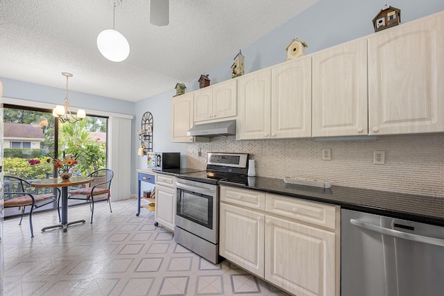 1 Danby Pl, Boynton Beach, FL 33426 - kitchen featuring stainless steel appliances, under cabinet range hood, dark countertops, a textured ceiling, and backsplash