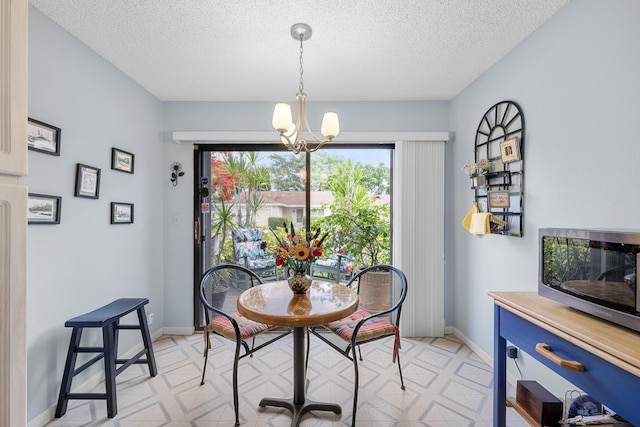 1 Danby Pl, Boynton Beach, FL 33426 - dining space with a textured ceiling, light floors, a chandelier, and baseboards