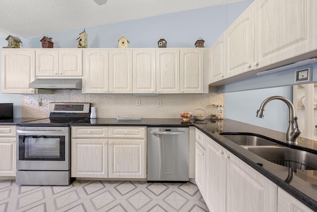 1 Danby Pl, Boynton Beach, FL 33426 - kitchen with appliances with stainless steel finishes, under cabinet range hood, a sink, dark countertops, and decorative backsplash