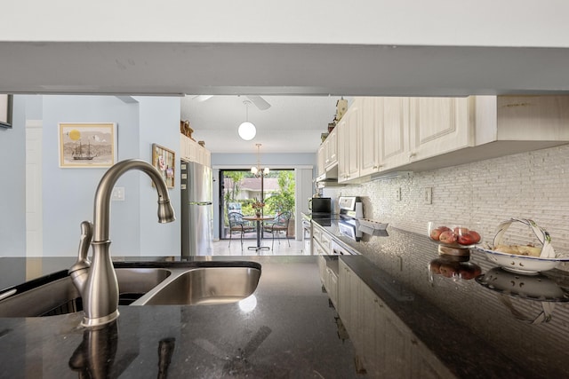 1 Danby Pl, Boynton Beach, FL 33426 - kitchen with a sink, tasteful backsplash, hanging light fixtures, and dark stone countertops