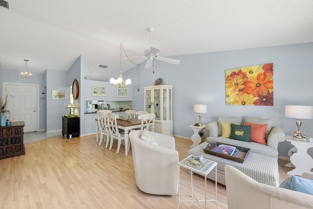 1 Danby Pl, Boynton Beach, FL 33426 - living area featuring a chandelier, ceiling fan, light wood-style floors, vaulted ceiling, and baseboards