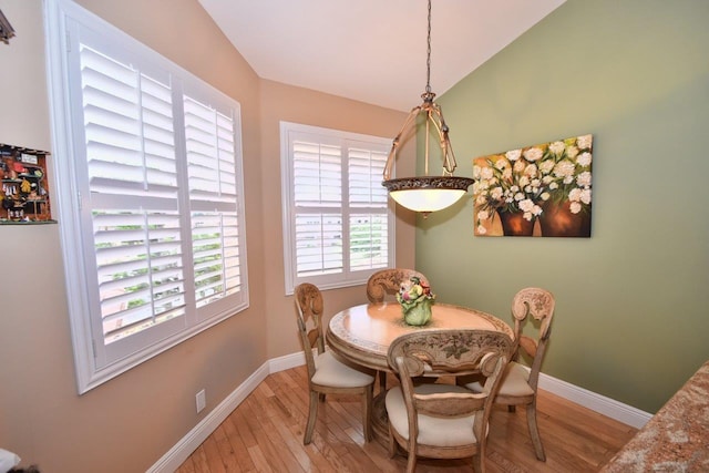5845 NW 24th Ave Unit 1103, Boca Raton, FL 33496 - dining room featuring light wood finished floors, baseboards, and lofted ceiling