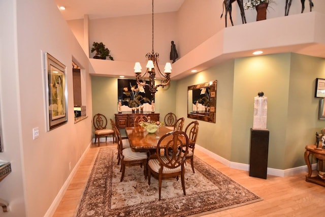 5845 NW 24th Ave Unit 1103, Boca Raton, FL 33496 - dining space with light wood-style flooring, a towering ceiling, a chandelier, baseboards, and recessed lighting
