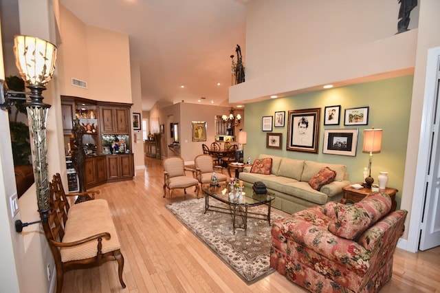 5845 NW 24th Ave Unit 1103, Boca Raton, FL 33496 - living room with a towering ceiling, light wood-style floors, a chandelier, and recessed lighting