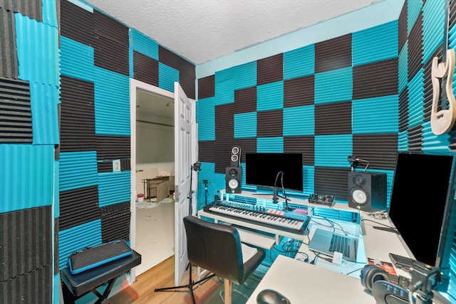 home office featuring wood finished floors and a textured ceiling