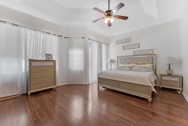 bedroom with hardwood / wood-style flooring, ceiling fan, vaulted ceiling, and baseboards