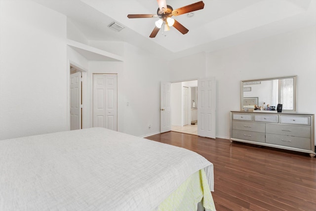 bedroom featuring wood finished floors, a ceiling fan, and a towering ceiling
