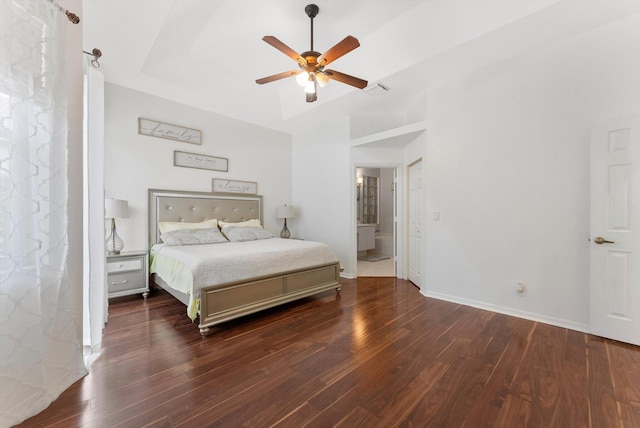 bedroom with wood finished floors, baseboards, a ceiling fan, and connected bathroom