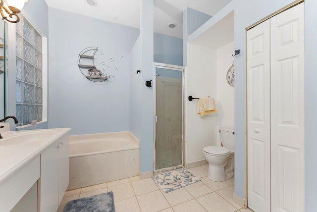 full bathroom with a shower stall, vanity, tile patterned flooring, a garden tub, and a closet