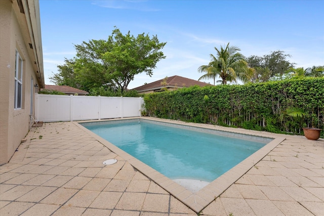 view of pool with a patio and a fenced backyard