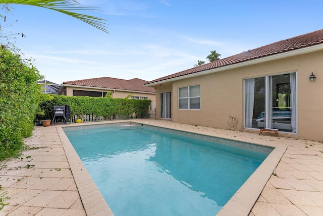 view of swimming pool featuring fence