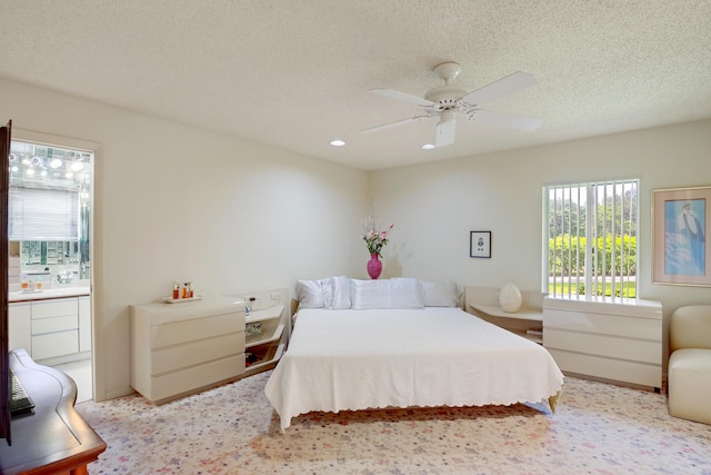 4721 Fountains Dr S, Lake Worth, FL 33467 - bedroom with multiple windows, connected bathroom, a ceiling fan, recessed lighting, and a textured ceiling