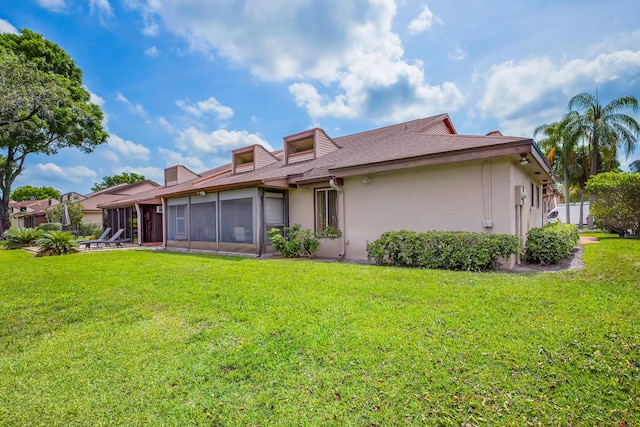4721 Fountains Dr S, Lake Worth, FL 33467 - back of property with a sunroom, stucco siding, a lawn, and a shingled roof