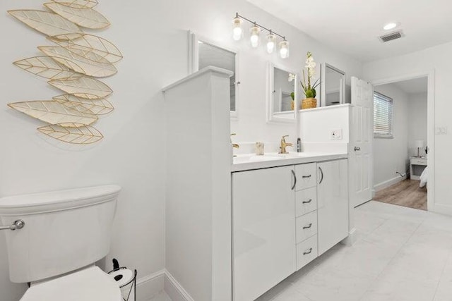 921 SE 13th Ct, Deerfield Beach, FL 33441 - bathroom featuring toilet, baseboards, and vanity