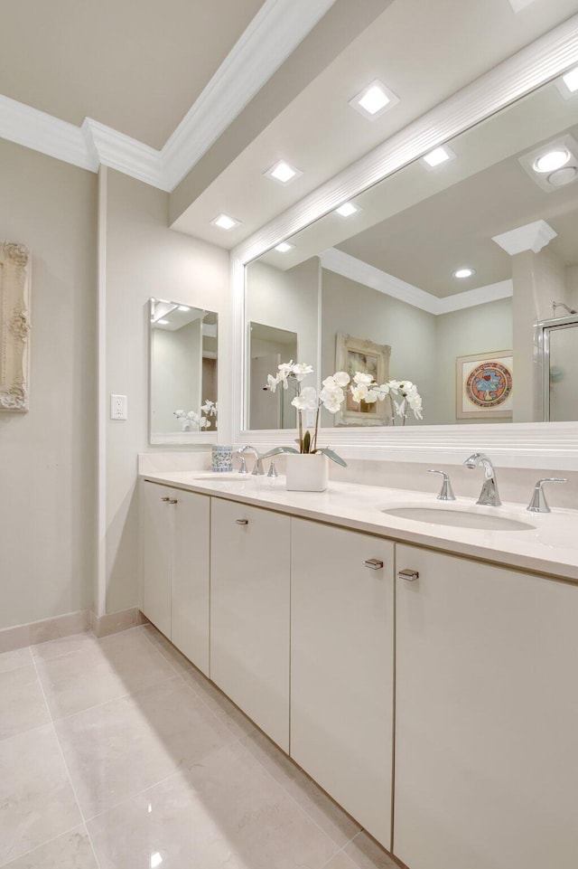 bathroom featuring ornamental molding, double vanity, and tile patterned floors