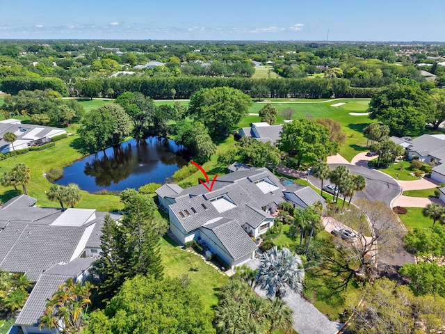 aerial view of residential area with a large body of water, a tree filled landscape, and a golf club