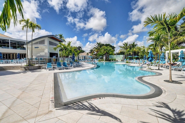 community pool featuring a patio and fence