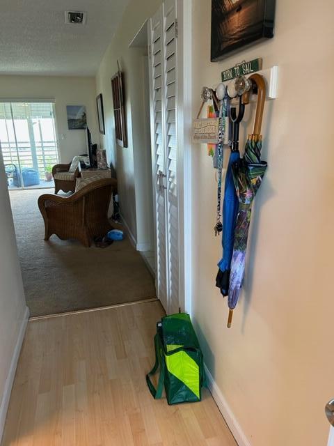 2724 S Garden Dr Unit 311, Lake Worth, FL 33461 - hallway featuring wood finished floors and baseboards