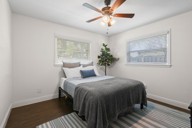 bedroom featuring multiple windows and baseboards