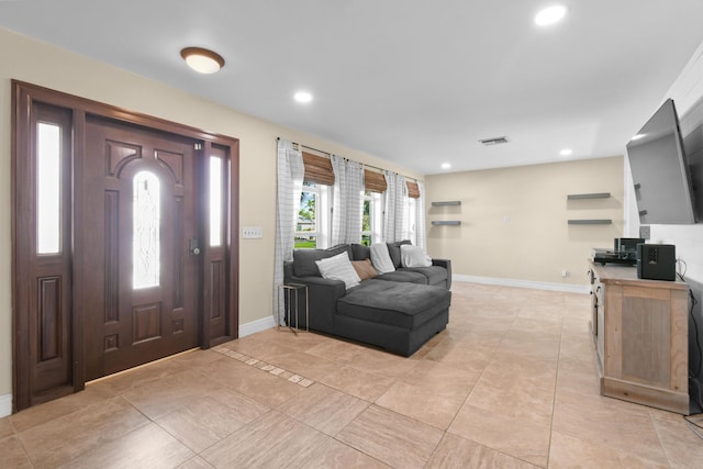 entrance foyer featuring baseboards, recessed lighting, and light tile patterned floors
