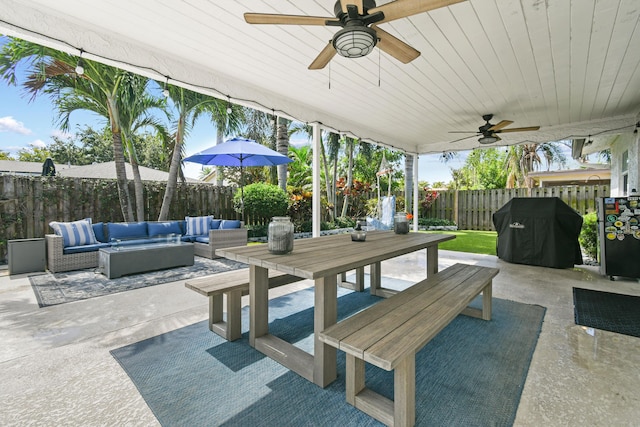 view of patio with an outdoor hangout area, outdoor dining space, a fenced backyard, a ceiling fan, and grilling area