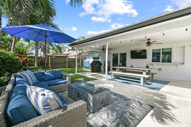 view of patio / terrace featuring ceiling fan, an outdoor living space, and fence
