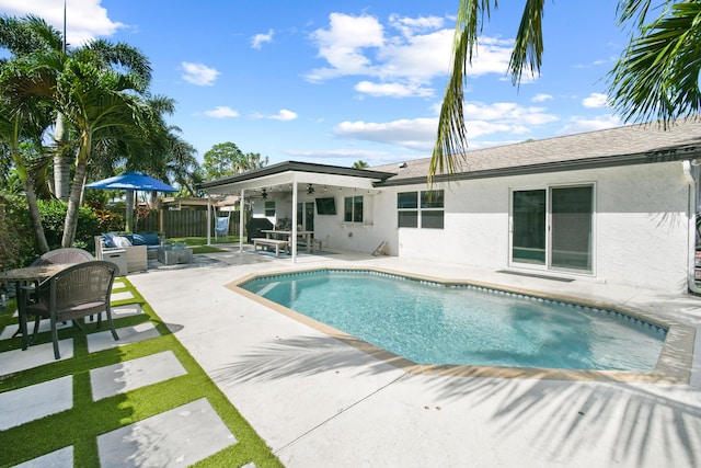 outdoor pool featuring a patio area, a ceiling fan, fence, and an outdoor living space