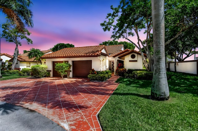 6078 Sunny Pointe Cir, Delray Beach, FL 33484 - mediterranean / spanish-style house with a tiled roof, stucco siding, an attached garage, driveway, and a lawn