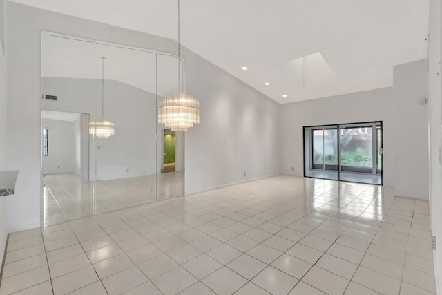 6078 Sunny Pointe Cir, Delray Beach, FL 33484 - empty room with light tile patterned flooring, high vaulted ceiling, a chandelier, and recessed lighting