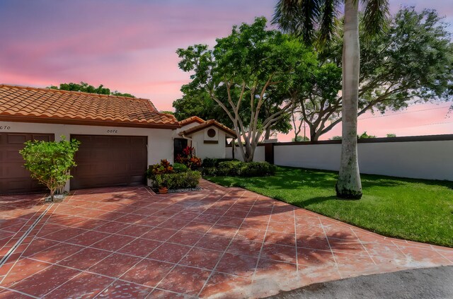 6078 Sunny Pointe Cir, Delray Beach, FL 33484 - mediterranean / spanish-style home featuring stucco siding, a tiled roof, a garage, and driveway