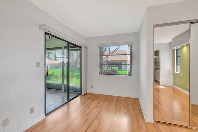 6078 Sunny Pointe Cir, Delray Beach, FL 33484 - spare room featuring wood finished floors, plenty of natural light, and baseboards