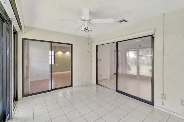 6078 Sunny Pointe Cir, Delray Beach, FL 33484 - spare room featuring ceiling fan, plenty of natural light, a textured ceiling, and light tile patterned flooring