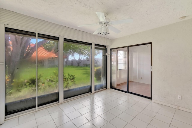 6078 Sunny Pointe Cir, Delray Beach, FL 33484 - spare room featuring a ceiling fan, a textured ceiling, a smoke detector, tile patterned floors, and baseboards