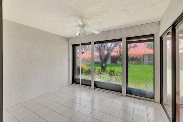 6078 Sunny Pointe Cir, Delray Beach, FL 33484 - unfurnished sunroom with plenty of natural light, a textured ceiling, a textured wall, and baseboards
