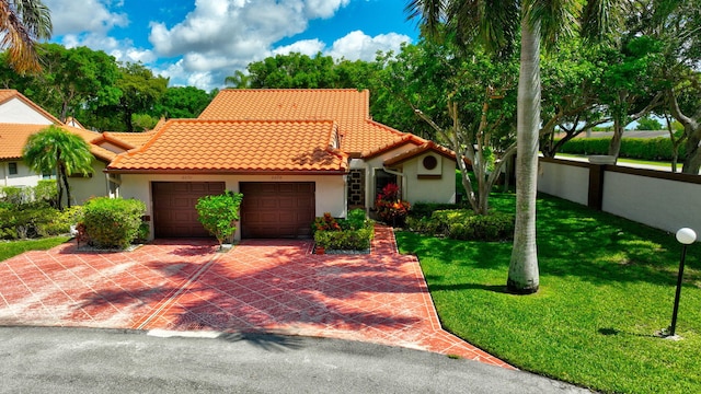 6078 Sunny Pointe Cir, Delray Beach, FL 33484 - mediterranean / spanish home with an attached garage, a tiled roof, stucco siding, a front lawn, and driveway