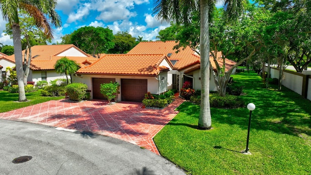 6078 Sunny Pointe Cir, Delray Beach, FL 33484 - mediterranean / spanish-style house featuring a tiled roof, stucco siding, an attached garage, and decorative driveway