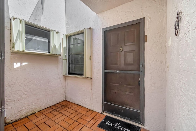 6078 Sunny Pointe Cir, Delray Beach, FL 33484 - doorway to property with stucco siding