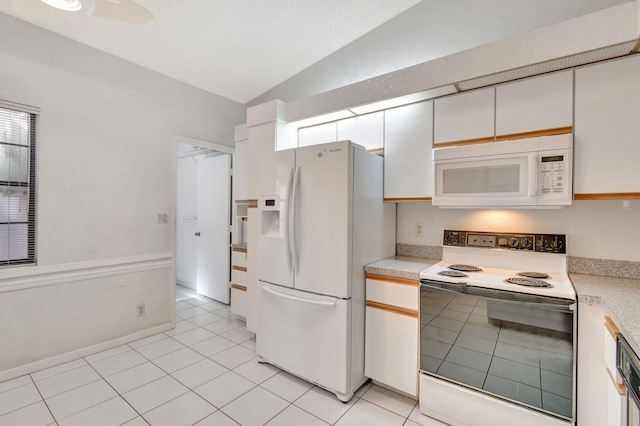 6078 Sunny Pointe Cir, Delray Beach, FL 33484 - kitchen with white appliances, lofted ceiling, light countertops, light tile patterned floors, and white cabinetry