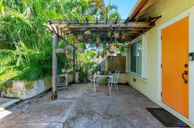 341 NE 7th Ave, Delray Beach, FL 33483 - view of patio / terrace with outdoor dining area, fence, and a pergola