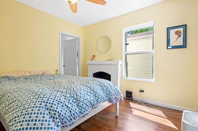 341 NE 7th Ave, Delray Beach, FL 33483 - bedroom featuring wood finished floors, baseboards, a fireplace, and ceiling fan