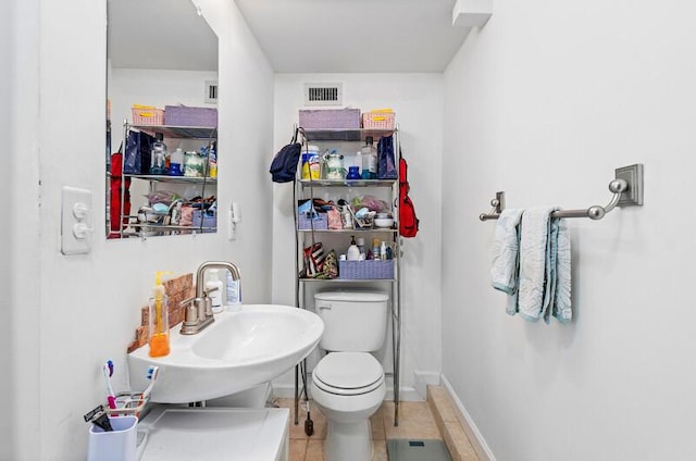 341 NE 7th Ave, Delray Beach, FL 33483 - half bath with a sink, toilet, tile patterned flooring, and baseboards