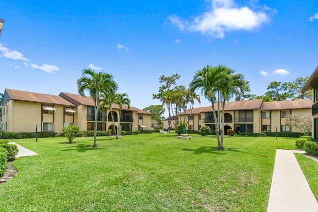 234 Pine Hov Cir Unit B-1, Greenacres, FL 33463 - view of community featuring a lawn and a residential view