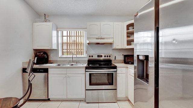 339 NW 5th Ave, Delray Beach, FL 33444 - kitchen featuring stainless steel appliances, a sink, under cabinet range hood, and white cabinetry