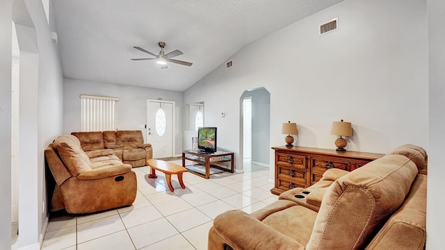 339 NW 5th Ave, Delray Beach, FL 33444 - living room with arched walkways, vaulted ceiling, ceiling fan, light tile patterned floors, and baseboards