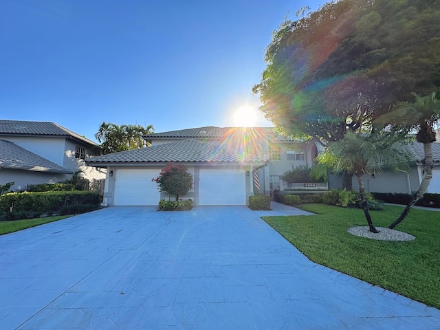 11666 Briarwood Cir Unit 1, Boynton Beach, FL 33437 - view of front of house featuring driveway, a front yard, a garage, stucco siding, and a tiled roof